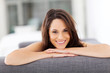 Photo: cheerful young woman lying on sofa laughing cheerful young woman lying on sofa laughing