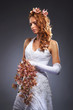 A young redhead woman posing in a wedding dress and flowers