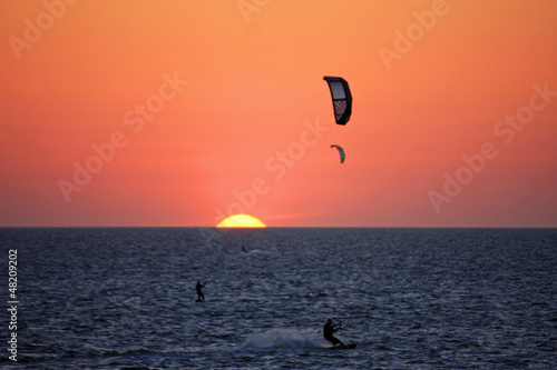 Photo: kitesurfers at sunset kitesurfers at sunset
