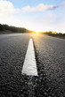 Asphalt road at sunset