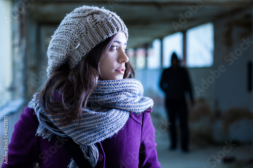 Photo: Worried Woman Stalked by a Man Worried Woman Stalked by a Man