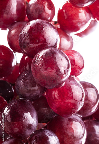 Photo: Ripe grapes with water drops, on white background Ripe grapes with water drops, on white background