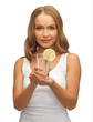 woman with lemon slice on glass of water