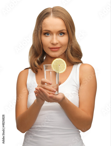 Photo: woman with lemon slice on glass of water woman with lemon slice on glass of water