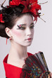 Photo: The young Japanese woman on a grey background The young Japanese woman on a grey background