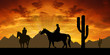 Silhouette cowboys with horses in the sunset