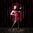 Theater Performer In Front Of Red Stage Curtains