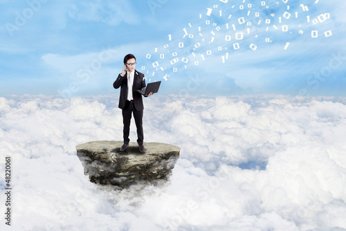Photo: Businessman and social media above clouds Businessman and social media above clouds
