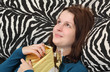 Photo: Young woman opening birthday or Christmas gift Young woman opening birthday or Christmas gift