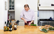 Photo: Man Cutting Spring Onions In Kitchen Man Cutting Spring Onions In Kitchen