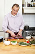 Photo: Man Preparing Meat At Kitchen Counter Man Preparing Meat At Kitchen Counter