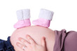 Photo: Schwangere mit Babyschuhen auf Bauch Schwangere mit Babyschuhen auf Bauch
