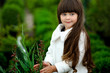 portrait of little girl outdoors in the style of gardener