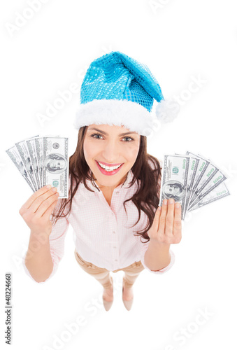 Photo: Woman in Santa hat holding money Woman in Santa hat holding money