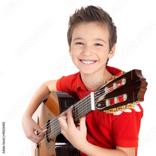 Photo: Happy boy is playing on acoustic guitar Happy boy is playing on acoustic guitar