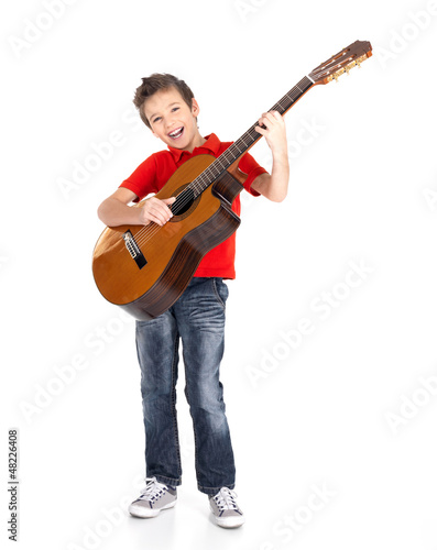Photo: boy sings and plays on the acoustic guitar boy sings and plays on the acoustic guitar