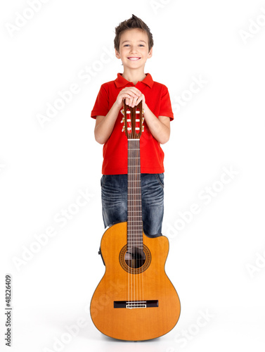 Photo: caucasian boy with acoustic guitar isolated on white caucasian boy with acoustic guitar isolated on white