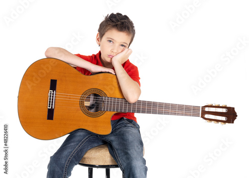 Photo: Sad white boy with a acoustic guitar in his hands. Sad white boy with a acoustic guitar in his hands.