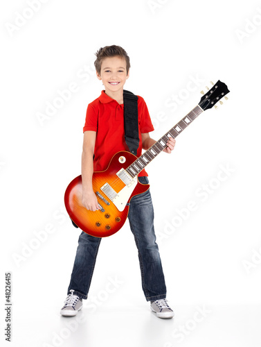 Photo: Portrait of young boy with a electric guitar isolated on white Portrait of young boy with a electric guitar isolated on white