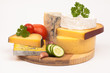 Various types of cheese and vegetables isolated on white