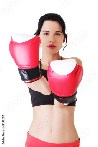 Photo: Boxing fitness woman wearing red gloves. Boxing fitness woman wearing red gloves.