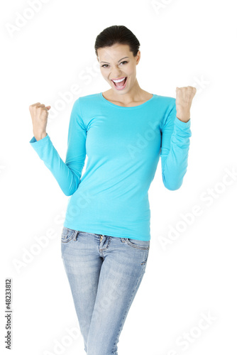 Photo: Excited happy young woman with fists up Excited happy young woman with fists up