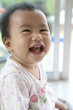 Photo: 10 month baby with funny face in home living room 10 month baby with funny face in home living room