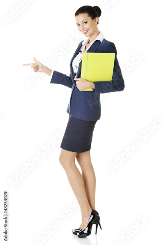 Photo: Success business woman pointing on copy space Success business woman pointing on copy space