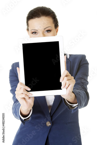 Photo: Business woman showing tablet PC Business woman showing tablet PC