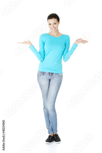 Photo: Young woman presenting copy space on her palm Young woman presenting copy space on her palm