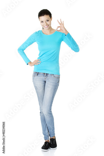 Photo: Beautiful success woman giving perfect gesture Beautiful success woman giving perfect gesture