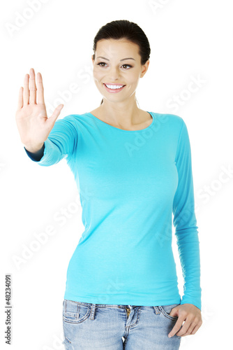Photo: Young woman making choose on abstract screen Young woman making choose on abstract screen