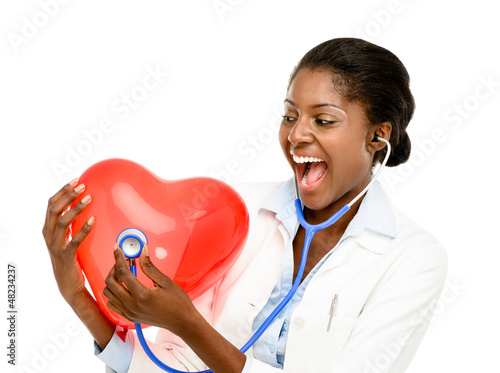 Photo: Happy African American trusted Nurse holding Red heart isolated Happy African American trusted Nurse holding Red heart isolated
