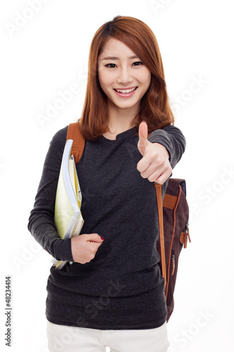 Photo: Young happy Asian student show thumb. Young happy Asian student show thumb.