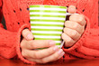 hands holding mug of hot drink close-up