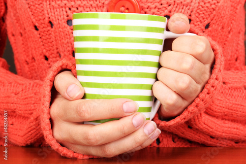 Photo: hands holding mug of hot drink close-up hands holding mug of hot drink close-up