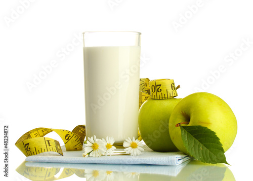 Photo: Glass of kefir, green apples and measuring tape isolated Glass of kefir, green apples and measuring tape isolated