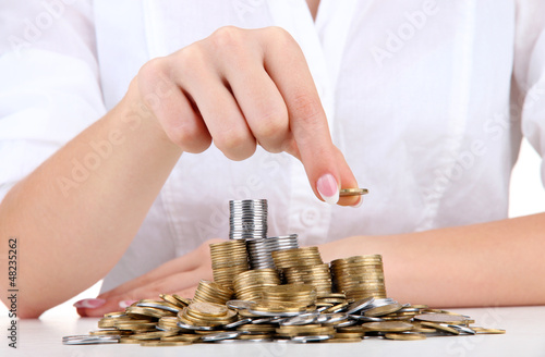 Photo: Woman hands with coins, close up Woman hands with coins, close up