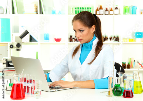 Photo: Young female scientist in laboratory. Young female scientist in laboratory.