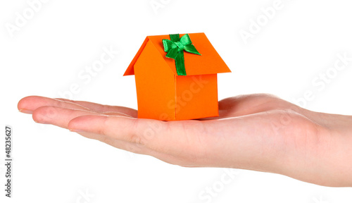 Photo: Small house in hand isolated on white Small house in hand isolated on white
