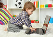 cute little boy and notebook in room