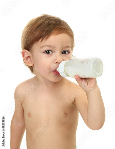 Photo: cute little boy with bottle of milk, isolated on white cute little boy with bottle of milk, isolated on white