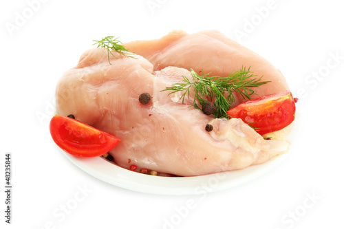Photo: raw chicken meat with spices on plate, isolated on white raw chicken meat with spices on plate, isolated on white