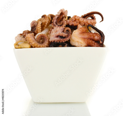 Photo: Tentacles of octopus in bowl isolated on white Tentacles of octopus in bowl isolated on white