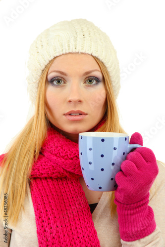 Photo: Attractive young woman holding cup with hot drink, isolated Attractive young woman holding cup with hot drink, isolated