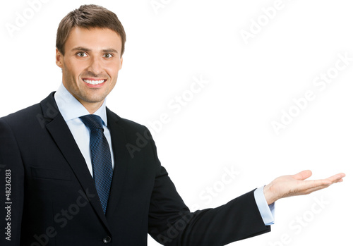 Photo: Businessman showing area for sign or copyspase Businessman showing area for sign or copyspase