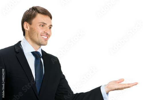 Photo: Businessman showing area for sign or copyspase Businessman showing area for sign or copyspase