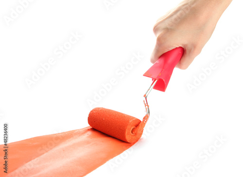 Photo: roller in hand with orange paint isolated on white roller in hand with orange paint isolated on white