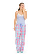 Young woman in pajamas yawing