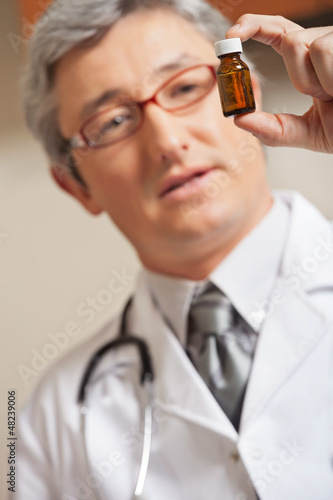 Photo: Physician Holding Medicine Bottle Physician Holding Medicine Bottle